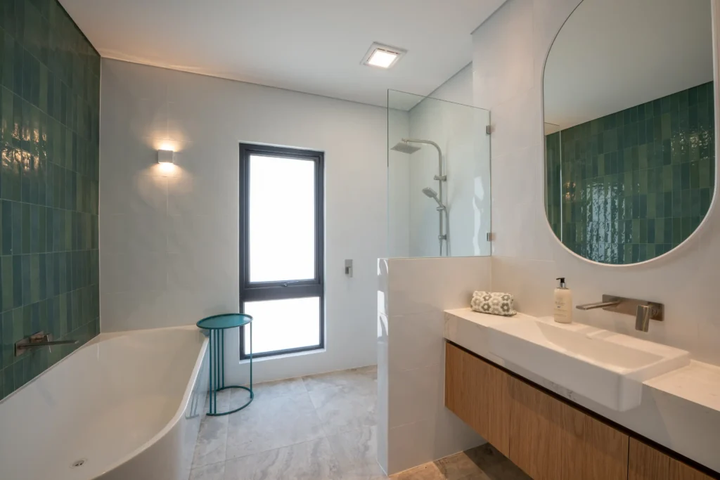 Entryway with clean lines, wooden cabinetry, and a modern staircase.