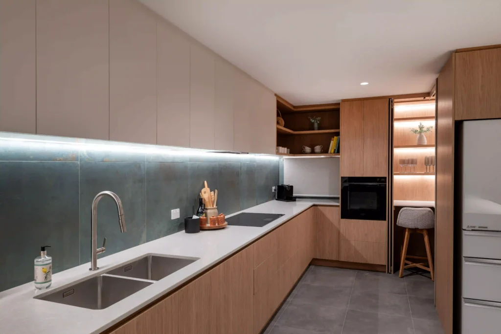 Modern kitchen with sleek cabinetry, a central island, and under-cabinet lighting.