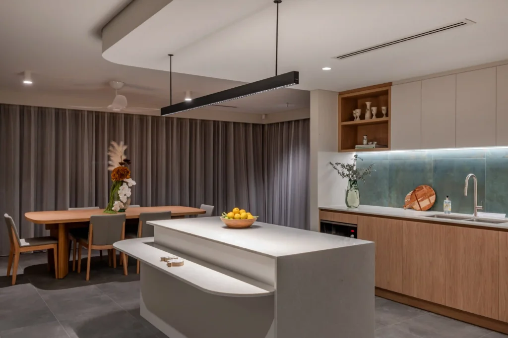 Interior view with wood-paneled walls and large glass windows overlooking a patio.