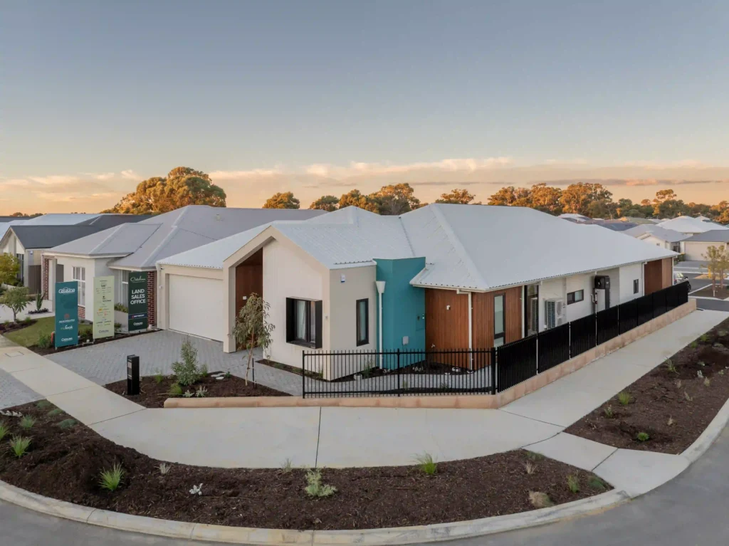 Modern exterior view of a home with flat roofing and large windows.