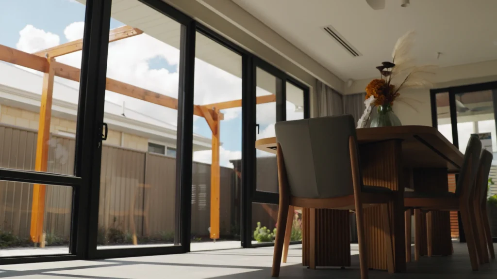 Contemporary kitchen with bar seating, pendant lights, and minimalist cabinetry.