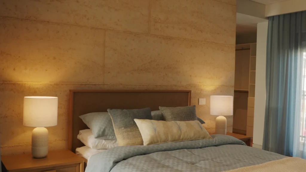 Cozy bedroom with wood walls, ambient lighting, and neutral bedding.