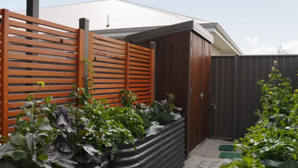Exterior view of a home with horizontal wooden slats and lush greenery.